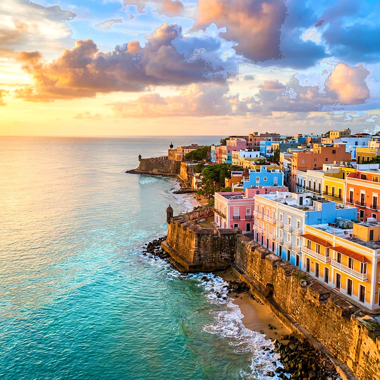 Aerial view of Old San Juan colorful houses and the Atlantic ocean at golden hour