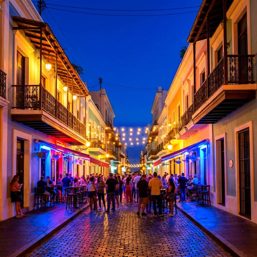Old San Juan street at night with lit colonial facades